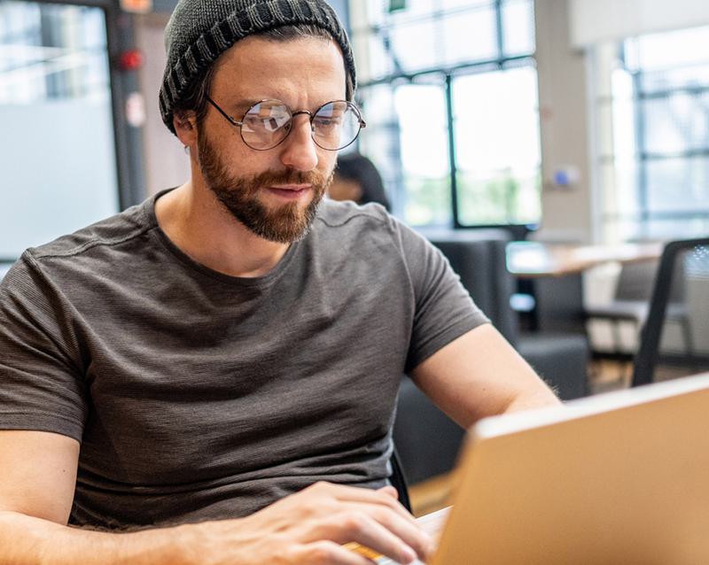 A user working through custom elearning content on work laptop